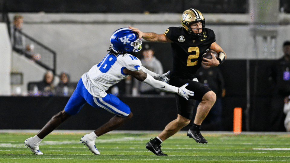 Diego Pavia #2 of the Vanderbilt Commodores runs the ball against defender Cam Dooley #18 of the Kentucky Wildcats in the second half at FirstBank Stadium on November 22, 2025 in Nashville, Tennessee.