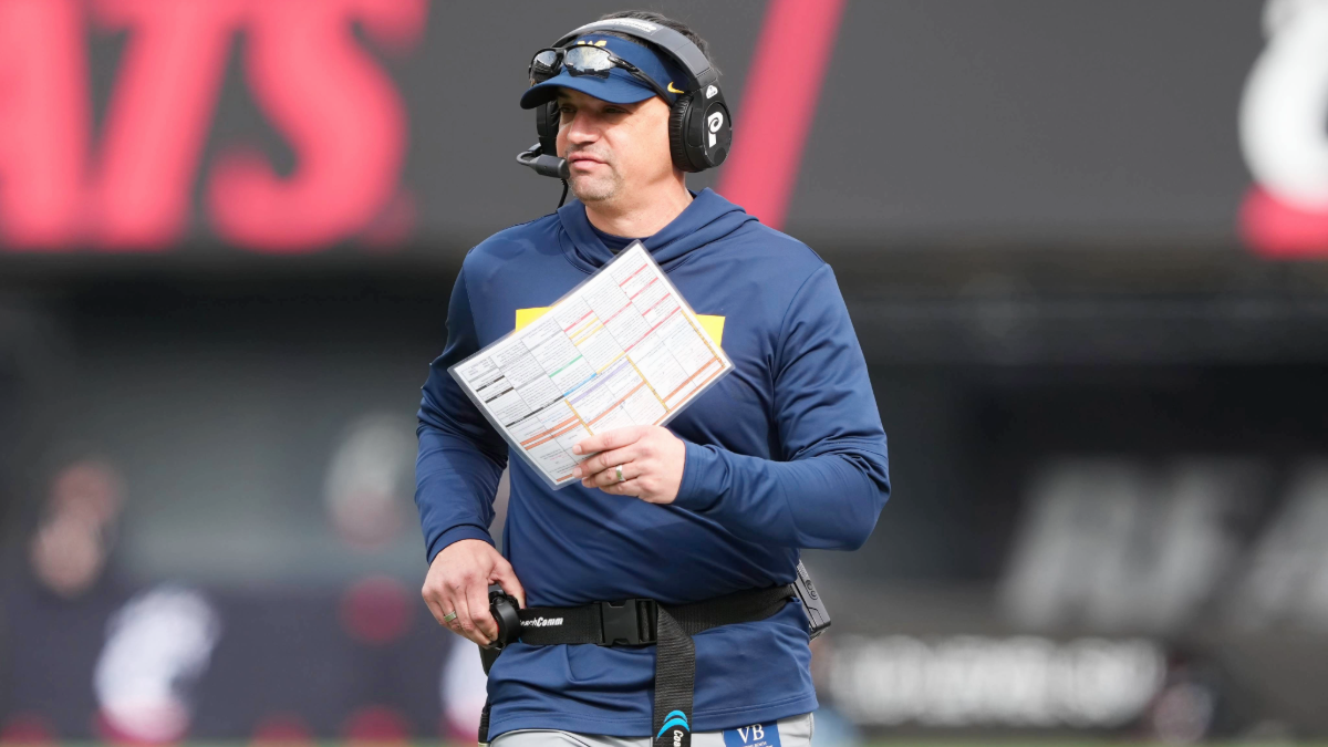 Head coach Neal Brown of the West Virginia Mountaineers looks on in the first quarter against the Cincinnati Bearcats at Nippert Stadium on November 09, 2024 in Cincinnati, Ohio.
