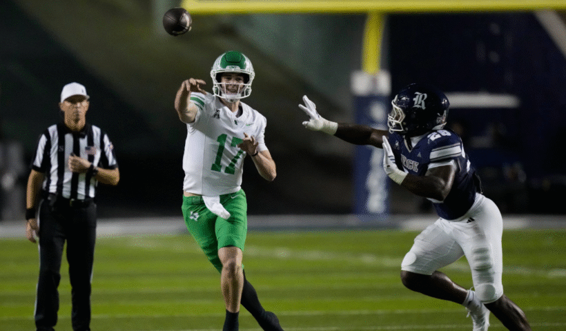 Drew Mestemaker #17 of the North Texas Mean Green passes under pressure from Tony Anyanwu #26 of the Rice Owls during the fourth quarter at Rice Stadium on November 22, 2025 in Houston, Texas.