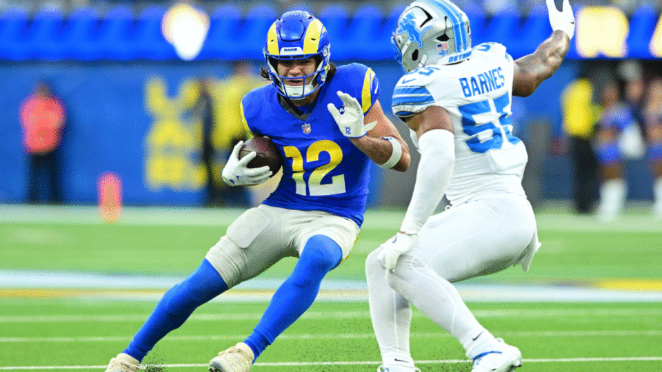 Puka Nacua #12 of the Los Angeles Rams runs after a catch against Derrick Barnes #55 of the Detroit Lions during the third quarter at SoFi Stadium on December 14, 2025 in Inglewood, California.