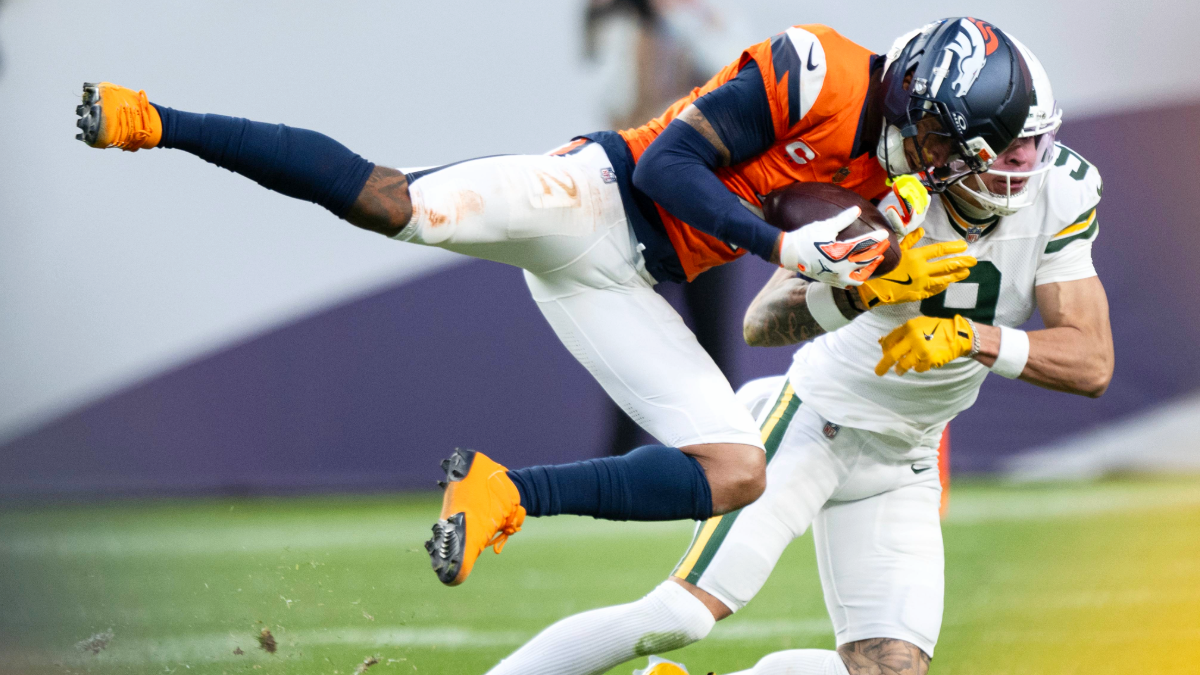 Cornerback Pat Surtain II (2) of the Denver Broncos intercepts a pass intended for running back wide receiver Christian Watson (9) of the Green Bay Packers on Sunday, Dec. 14, 2025, at Empower Field at Mile High Stadium in Denver, Colo.