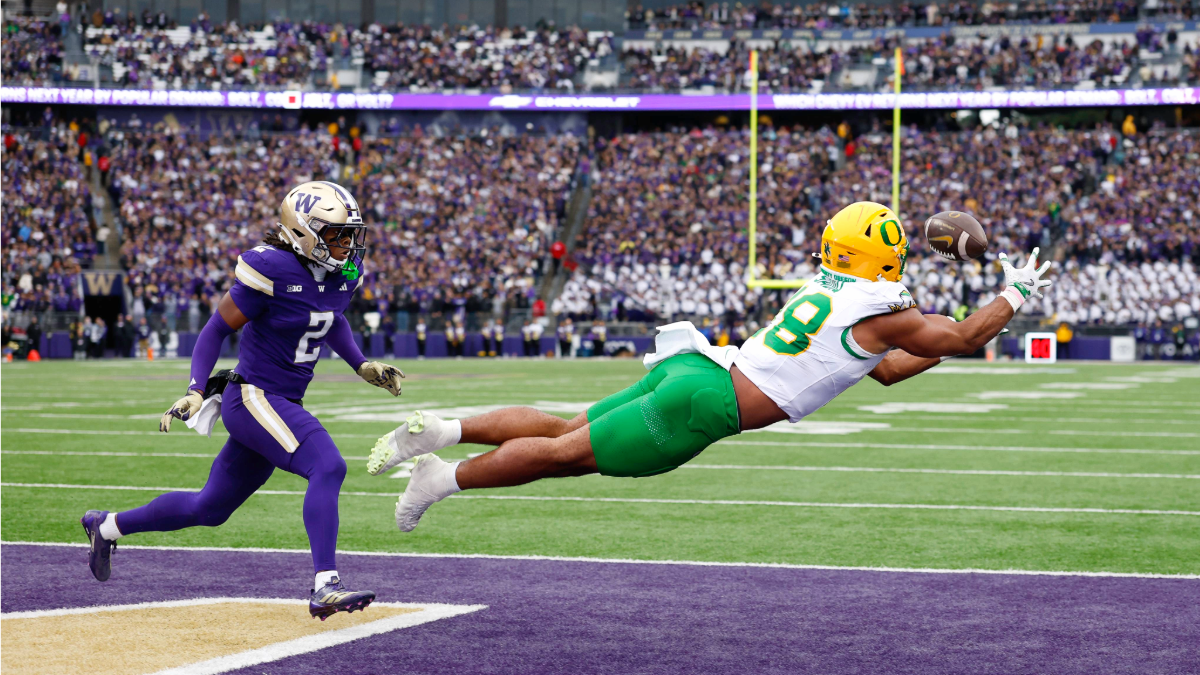 Kenyon Sadiq #18 of the Oregon Ducks dives for a ball in the endzone against Rahshawn Clark #2 of the Washington Huskies during the second quarter of the game at Husky Stadium on November 29, 2025 in Seattle, Washington.