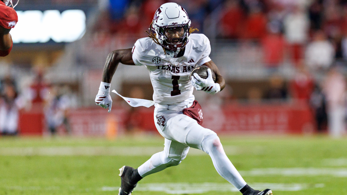Mario Craver #1 of the Texas A&M Aggies runs the ball during a game against the Arkansas Razorbacks at Donald W. Reynolds Razorback Stadium on October 18, 2025 in Fayetteville, Arkansas. The Aggies defeated the Razorbacks 45-42.