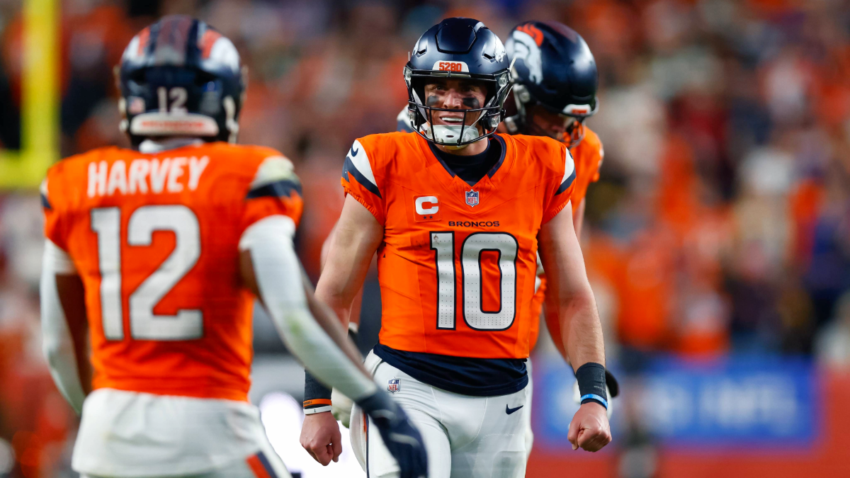 Bo Nix #10 of the Denver Broncos celebrates after a touchdown with RJ Harvey #12 during the third quarter against the Green Bay Packers at Empower Field at Mile High on December 14, 2025 in Denver, Colorado.