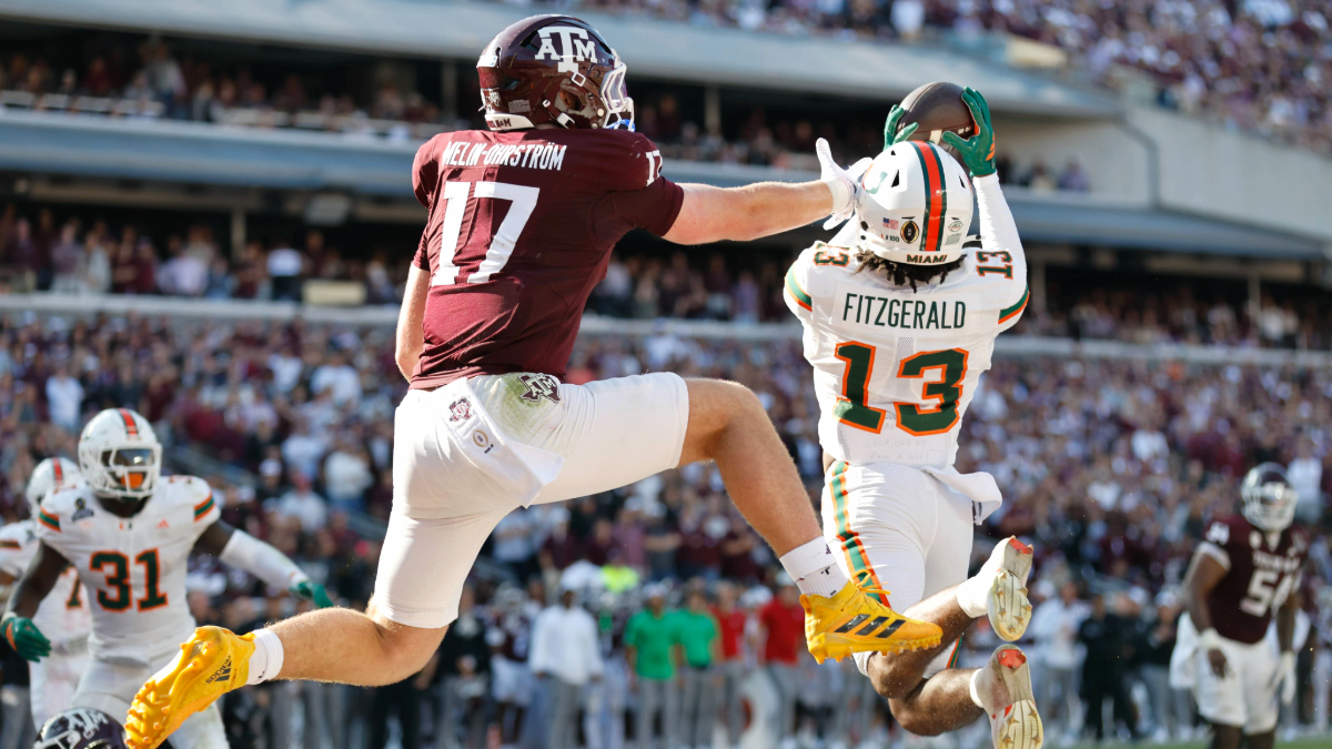 Defensive back Bryce Fitzgerald #13 of the Miami Hurricanes intercepts a ball in front of tight end Theo Melin Öhrström #17 of the Texas A&M Aggies during the second half at Kyle Field on December 20, 2025 in College Station, Texas.