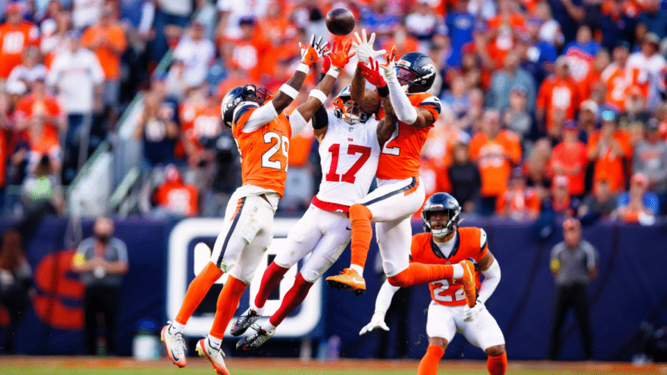 Ja'Quan McMillian #29 and Pat Surtain II #2 of the Denver Broncos defend a pass intended for Wan'Dale Robinson #17 of the New York Giants as Brandon Jones #22 of the Denver Broncos looks on during the fourth quarter at Empower Field at Mile High on October 19, 2025 in Denver, Colorado.