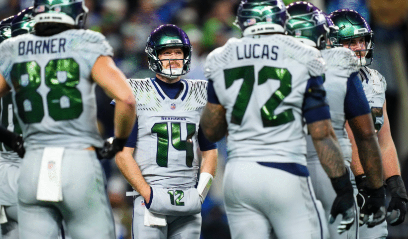 Sam Darnold #14 of the Seattle Seahawks looks on from the field during an NFL football game against the Los Angeles Rams at Lumen Field on December 18, 2025 in Seattle, Washington.