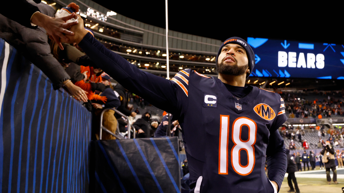 Caleb Williams #18 of the Chicago Bears high fives with fans after his team defeated the Green Bay Packers at Soldier Field on December 20, 2025 in Chicago, Illinois.