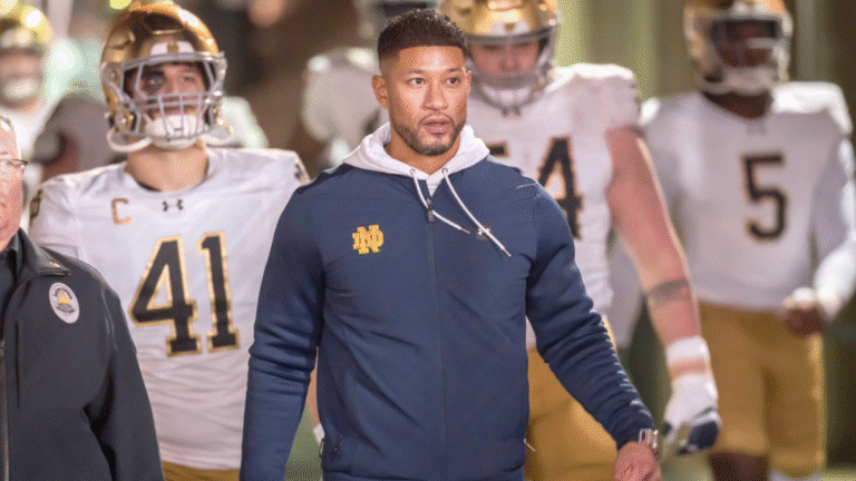Head Coach Marcus Freeman of the Notre Dame Fighting Irish leads his team into the stadium to start the second half of a college football game against the Stanford Cardinal on November 29, 2025 at Stanford Stadium in Palo Alto, California.