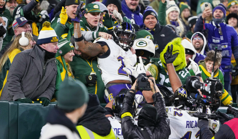 Derrick Henry #22 of the Baltimore Ravens celebrates a touchdown with a "Lambeau Leap" during the second half of an NFL football game against the Green Bay Packers at Lambeau Field on December 27, 2025 in Green Bay, Wisconsin.