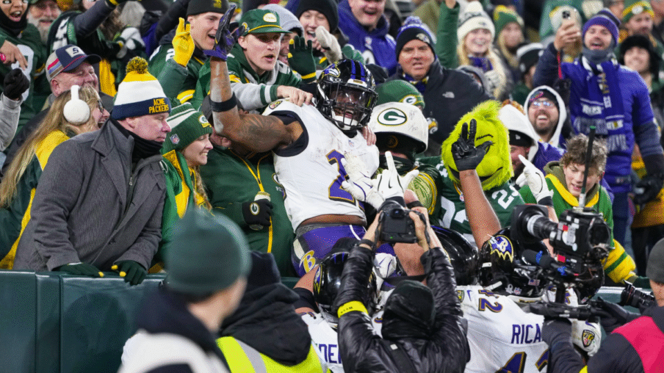 Derrick Henry #22 of the Baltimore Ravens celebrates a touchdown with a "Lambeau Leap" during the second half of an NFL football game against the Green Bay Packers at Lambeau Field on December 27, 2025 in Green Bay, Wisconsin.