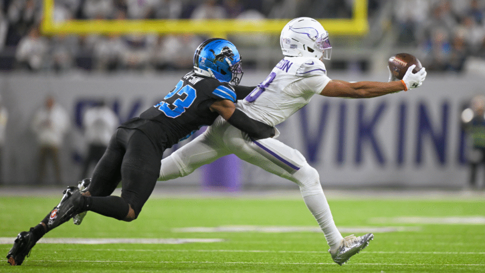 Minnesota Vikings wide receiver Justin Jefferson (18) catches a pass for a 10-yard gain as Detroit Lions defensive back Rock Ya-Sin (23) defends during the fourth quarter of a NFL game between the Minnesota Vikings and Detroit Lions on December 25, 2025, at U.S. Bank Stadium in Minneapolis, Minnesota.