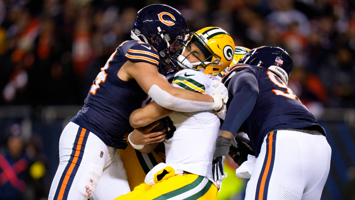 Austin Booker #94 of the Chicago Bears hits Jordan Love #10 of the Green Bay Packers during an NFL football game at Solider Field on December 20, 2025 in Chicago, Illinois.