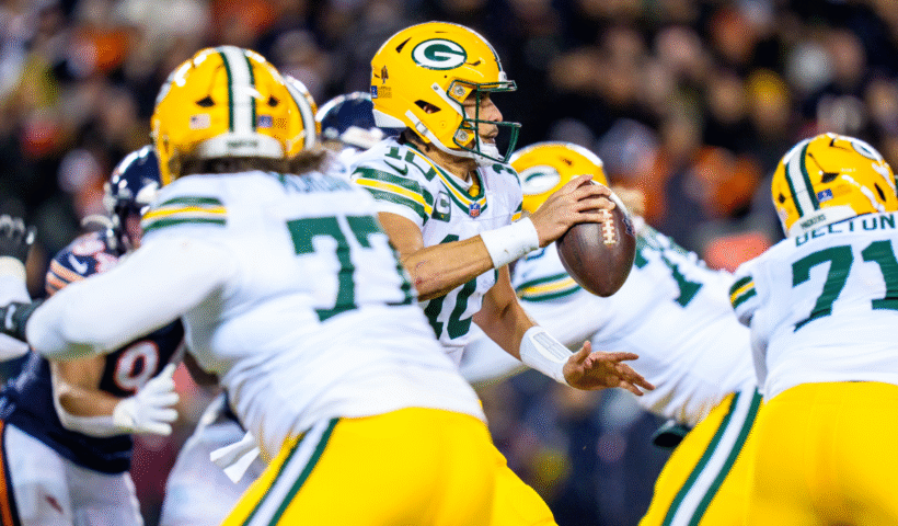 Jordan Love #10 of the Green Bay Packers looks to pass under pressure during the first half of an NFL football game against the Chicago Bears at Solider Field on December 20, 2025 in Chicago, Illinois.