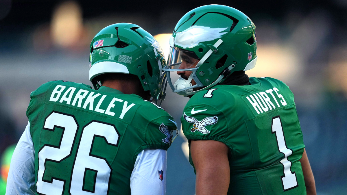 Jalen Hurts #1 and Saquon Barkley #26 of the Philadelphia Eagles speak during warm ups prior to the game against the Washington Commanders at Lincoln Financial Field on January 04, 2026 in Philadelphia, Pennsylvania.