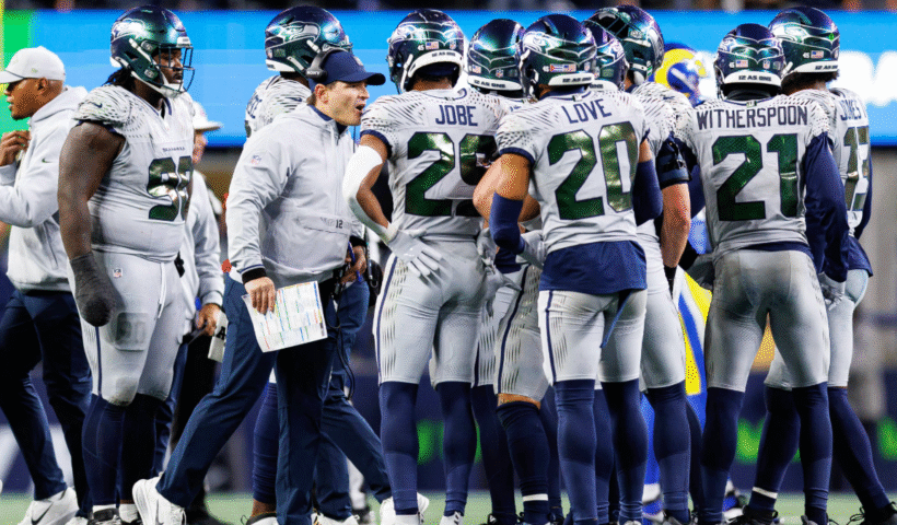 Head coach Mike MacDonald of the Seattle Seahawks interacts with the defense on the field during the fourth quarter of an NFL football game against the Los Angeles Rams at Lumen Field on December 18, 2025 in Seattle, Washington.
