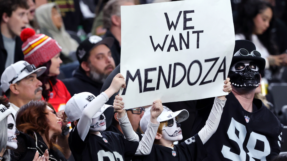 Las Vegas Raiders fans Ezra Kheel (L) and his brother Alexandros Kheel of Nevada hold up a sign referencing Indiana quarterback Fernando Mendoza, the 2025 Heisman Trophy recipient, in the second quarter of the Raiders' game against the Kansas City Chiefs at Allegiant Stadium on January 04, 2026 in Las Vegas, Nevada. The Raiders earlier clinched the No. 1 overall pick in the 2026 NFL draft. The Raiders defeated the Chiefs 14-12.