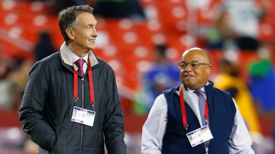 Cris Collinsworth and Mike Tirico stroll across the field prior to the Seattle Seahawks game versus the Washington Commanders at Northwest Stadium on November 02, 2025, in Landover, MD.