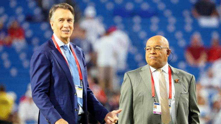 Sportscasters Cris Collinsworth and Mike Tirico on the field before announcing a game between the Buffalo Bills and the New England Patriots at Highmark Stadium on October 5, 2025 in Orchard Park, New York.