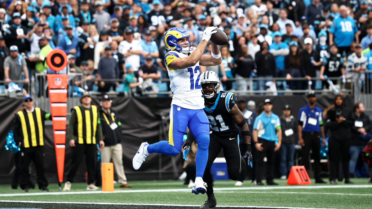 Puka Nacua #12 of the Los Angeles Rams scores a 14 yard touchdown against Nick Scott #21 of the Carolina Panthers during the first quarter in the NFC Wild Card Playoff game at Bank of America Stadium on January 10, 2026 in Charlotte, North Carolina.