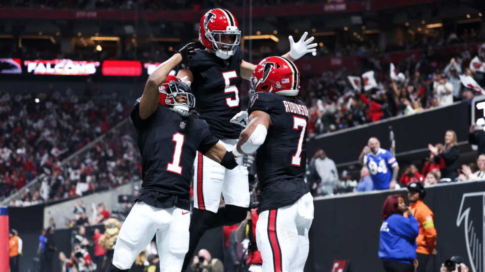 Bijan Robinson #7 celebrates a touchdown with Darnell Mooney #1 and Drake London #5 of the Atlanta Falcons during the first quarter of an NFL football game against the Los Angeles Rams at Mercedes-Benz Stadium on December 29, 2025 in Atlanta, Georgia.