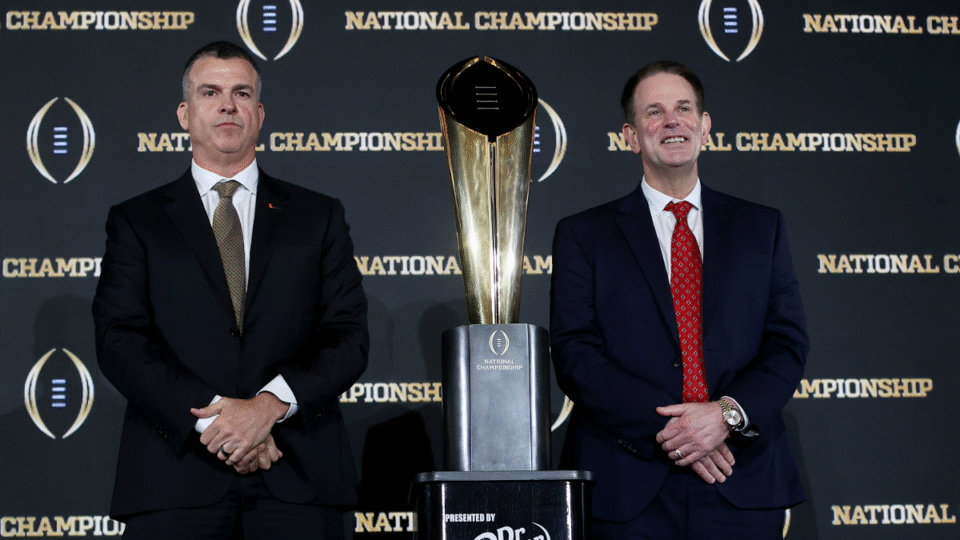 Head Coaches Mario Cristobal of the Miami Hurricanes and Curt Cignetti of the Indiana Hoosiers pose for a photo with the CFP National Championship trophy during the CFP National Championship Head Coaches News Conference at JW Marriott Marquis Miami on January 18, 2026 in Miami, Florida.