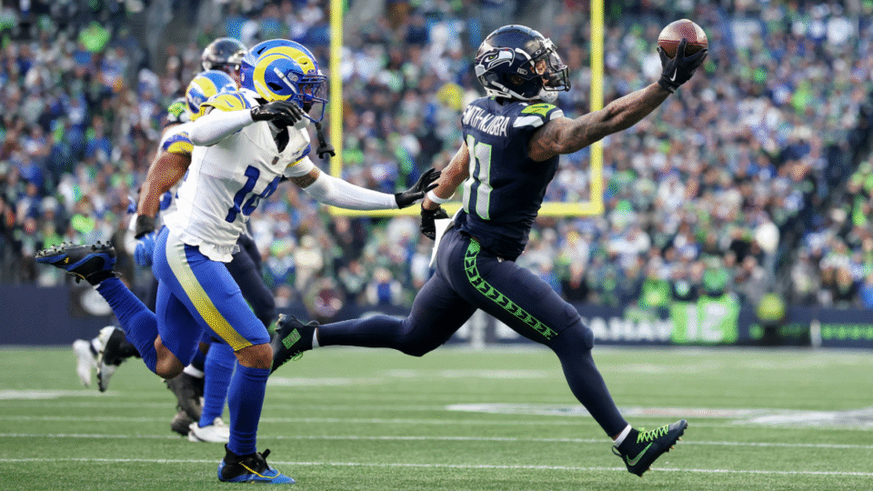 Jaxon Smith-Njigba #11 of the Seattle Seahawks pulls in a one handed catch in front of Cobie Durant #14 of the Los Angeles Rams during the first quarter in the NFC Championship game at Lumen Field on January 25, 2026 in Seattle, Washington.