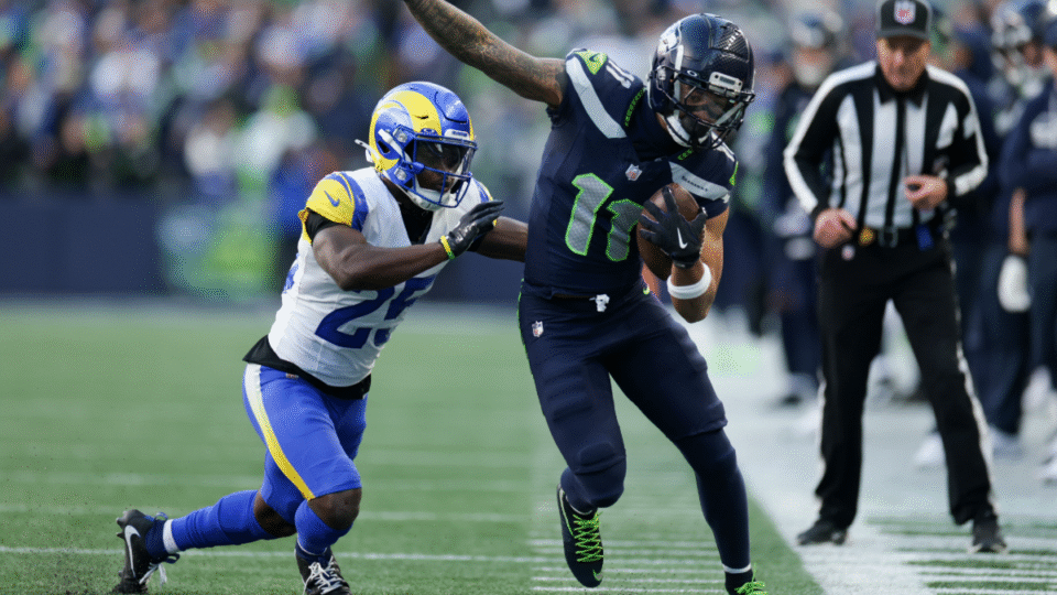 Seattle Seahawks wide receiver Jaxon Smith-Njigba (11) tries to stay in-bounds on a 9-yard reception after being forced out of bounds by Los Angeles Rams cornerback Roger McCreary (25) during the first quarter of the NFC championship game at Lumen Field on Sunday, Jan. 25, 2026 in Seattle, CA.