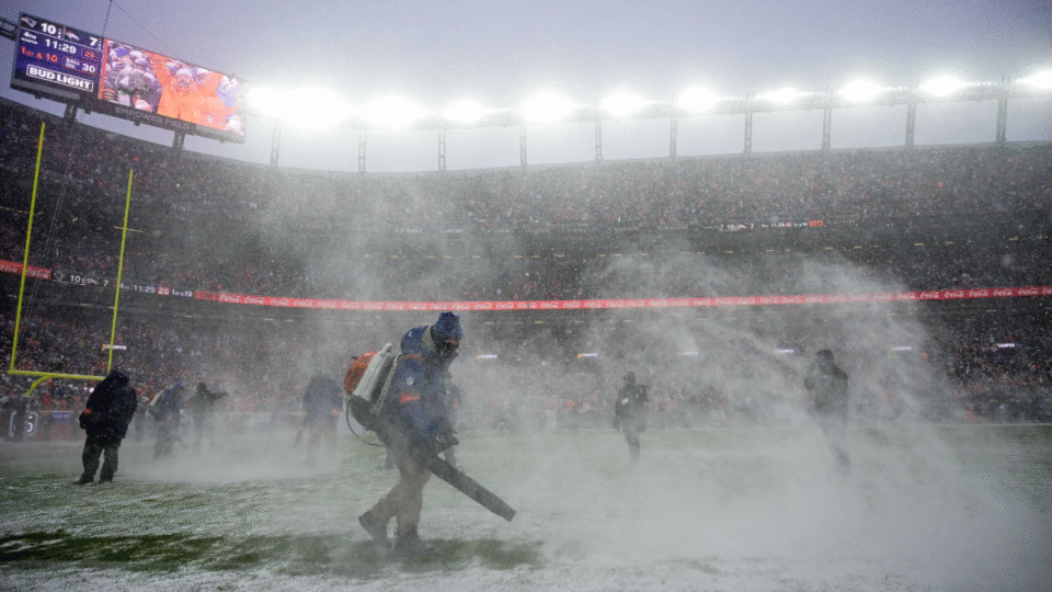 Venue personnel clear snow using snowblowers in the fourth quarter of the AFC Championship Game between the Denver Broncos and the New England Patriots at Empower Field at Mile High on January 25, 2026 in Denver, Colorado.