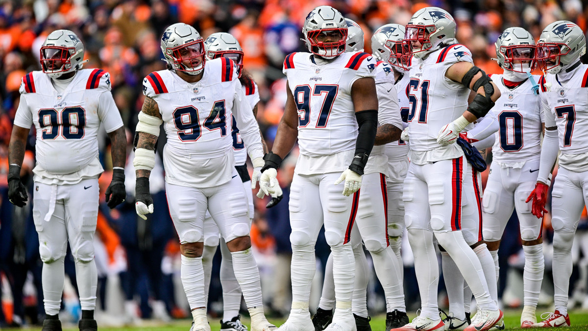 New England Patriots defensive players, including defensive tackle Christian Barmore (90), defensive tackle Cory Durden (94), defensive end Milton Williams (97), and New England Patriots linebacker Jack Gibbens (51) look on in the AFC Championship Game against the Denver Broncos at Empower Field at Mile High on January 25, 2026 in Denver, Colorado.
