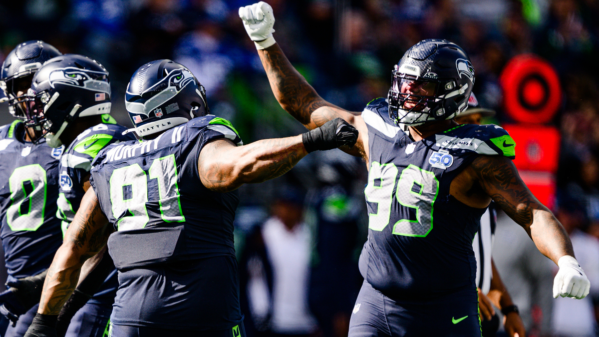 Leonard Williams #99 and Byron Murphy II #91 of the Seattle Seahawks celebrate during the third quarter of the game against the New Orleans Saints at Lumen Field on September 21, 2025 in Seattle, Washington.