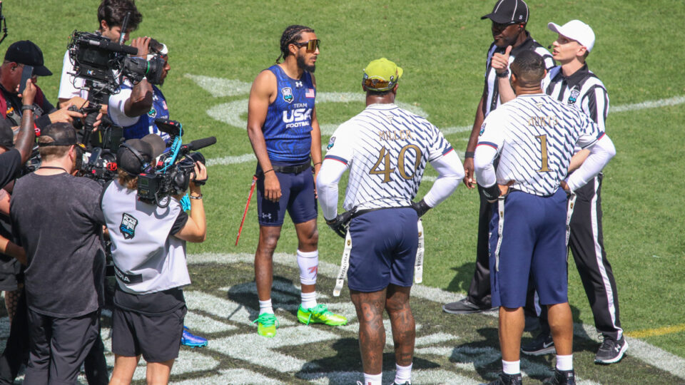 Team USA quarterback Darrell "Housh" Doucette participates in the coin toss across from NFL players Von Miller and Jalen Hurts at the Fanatics Flag Football Classic in Los Angeles, Calif. on March 21, 2026.