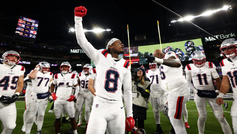 Stefon Diggs #8 of the New England Patriots talks to teammates in a huddle prior to the game against the Baltimore Ravens at M&T Bank Stadium on December 21, 2025 in Baltimore, Maryland.