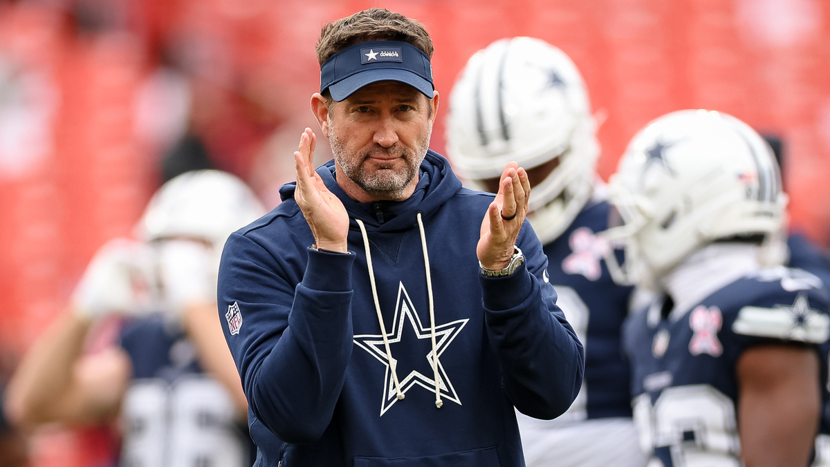 Head coach Brian Schottenheimer of the Dallas Cowboys watches warmups before the NFL game against the Washington Commanders at Northwest Stadium on December 25, 2025 in Landover, Maryland.