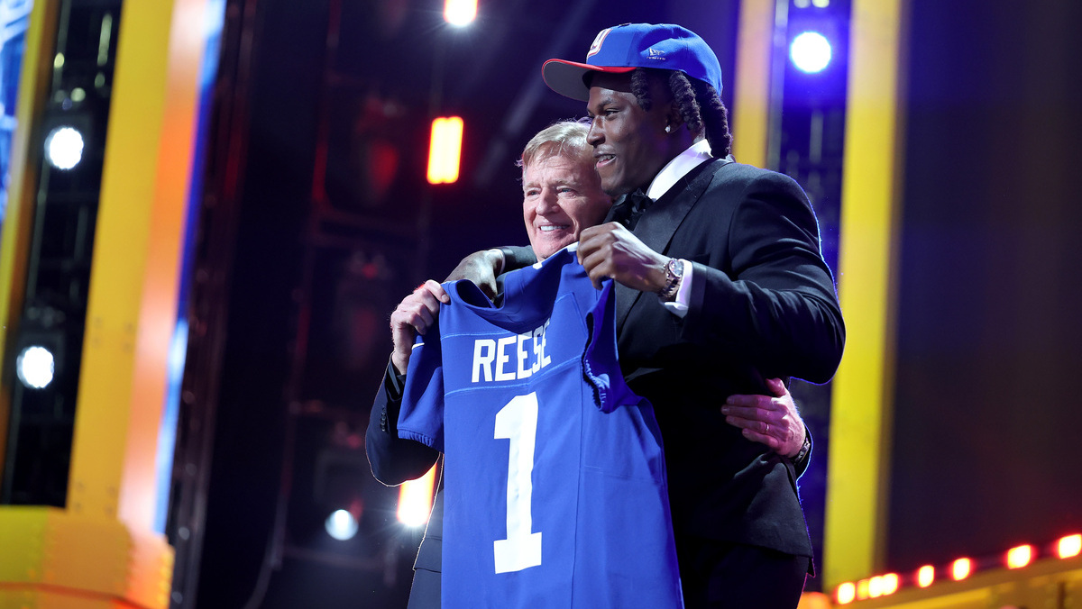 Arvell Reese (L) of Ohio State poses with NFL Commissioner Roger Goodell (R) after being selected fifth overall pick by the New York Giants during Round One of the 2026 NFL Draft at Acrisure Stadium on April 23, 2026 in Pittsburgh, Pennsylvania.