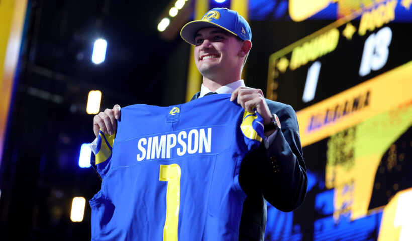 Ty Simpson of Alabama celebrates after being selected thirteenth overall pick by the Los Angeles Rams during Round One of the 2026 NFL Draft at Acrisure Stadium on April 23, 2026 in Pittsburgh, Pennsylvania.