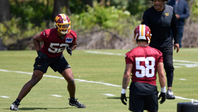 Washington Commanders linebacker Sonny Styles (52) runs a drill as linebacker coach Ken Norton Jr. looks on during rookie mini camp at Commanders Park on Friday, May 8, 2026.