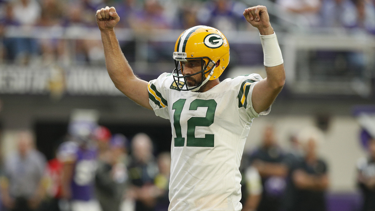 Aaron Rodgers #12 of the Green Bay Packers celebrates a touchdown during the third quarter in the game against the Minnesota Vikings at U.S. Bank Stadium on September 11, 2022 in Minneapolis, Minnesota.