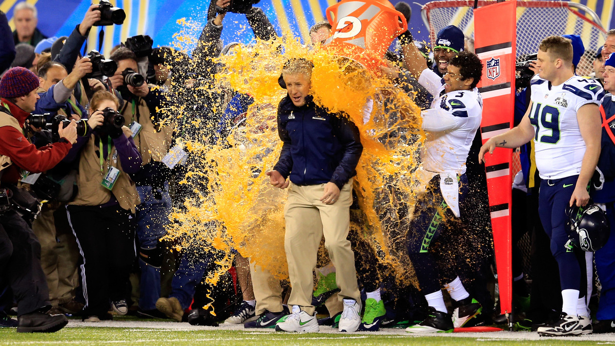 Tight end Zach Miller #86 and quarterback Russell Wilson #3 of the Seattle Seahawks dump Gatorade on head coach Pete Carroll in the fourth quarter of Super Bowl XLVIII against the Denver Broncos at MetLife Stadium on February 2, 2014 in East Rutherford, New Jersey. The Seattle Seahawks won 43-8.