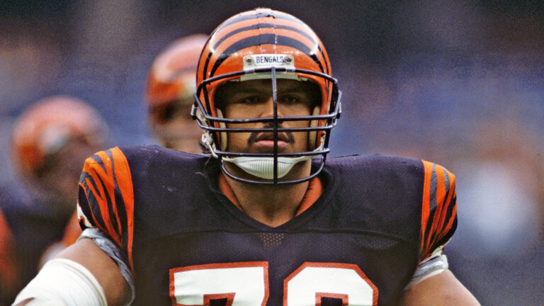 Tackle Anthony Munoz #78 of the Cincinnati Bengals looks on from the field during a game against the Dallas Cowboys at Riverfront Stadium on December 8, 1985 in Cincinnati, Ohio. The Bengals defeated the Cowboys 50-24.