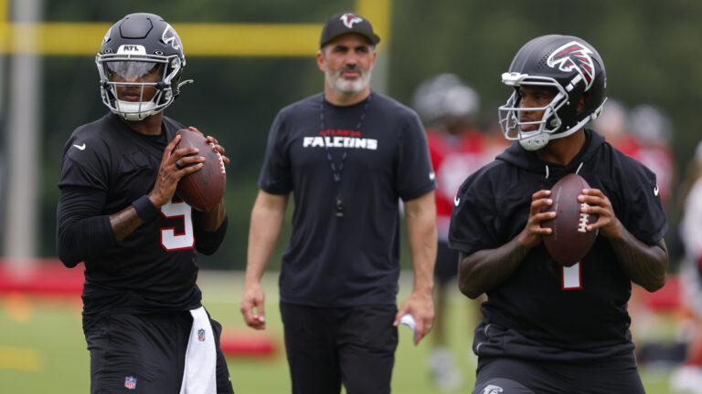 Michael Penix Jr. #9 of the Atlanta Falcons runs through drills alongside Tua Tagovailoa #1 as head coach Kevin Stefanski looks on during OTA's at IBM Performance Field on May 27, 2026 in Flowery Branch, Georgia.