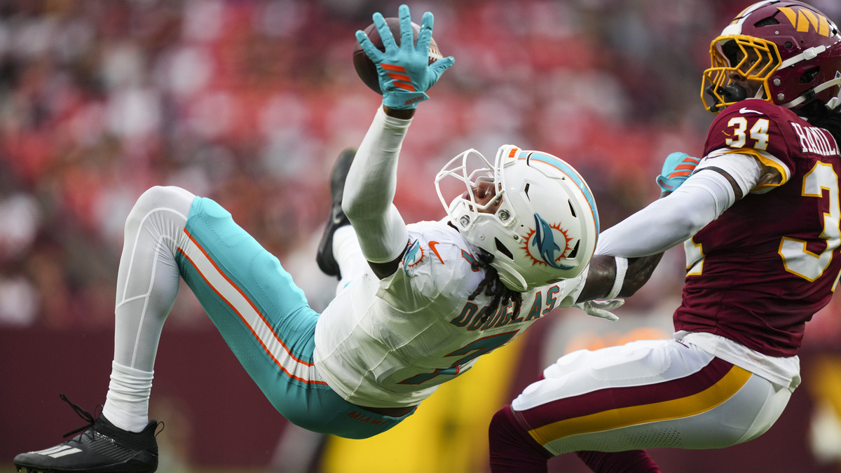 Caleb Douglas #7 of the Miami Dolphins goes up for the ball during the NFL preseason football game against the Washington Commanders at Northwest Stadium on August 14, 2026 in Landover, Maryland.