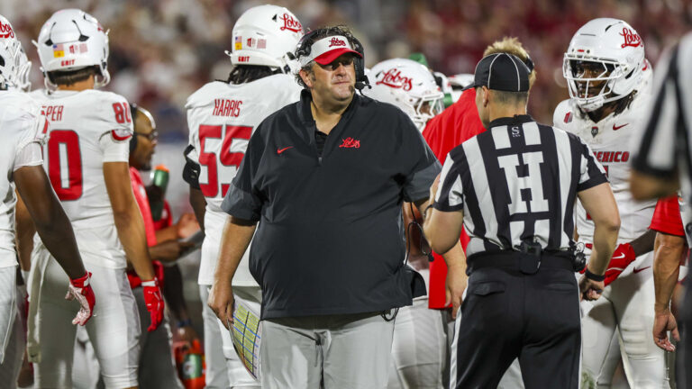 New Mexico Lobos head coach Jason Eck converses with the head line judge Ryan Hagan during the college football game between the Oklahoma Sooners and the New Mexico Lobos on September 19, 2026 at Gaylord Family Oklahoma Memorial Stadium in Norman, Oklahoma.