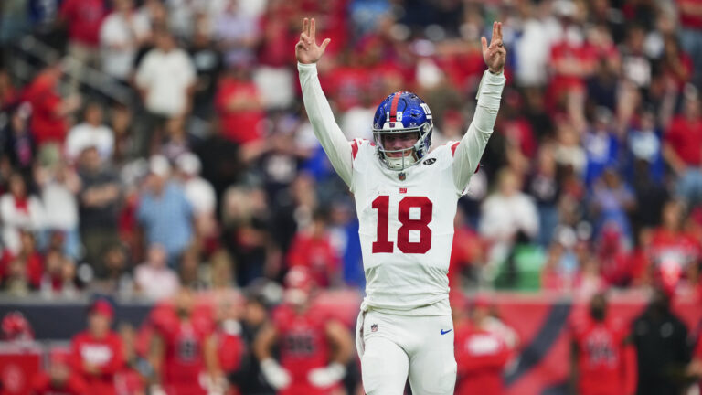 J.J. McCarthy #18 of the New York Giants celebrates after scoring a touchdown against the Houston Texans during overtime of an NFL football game at Reliant Stadium on October 25, 2026 in Houston, Texas.