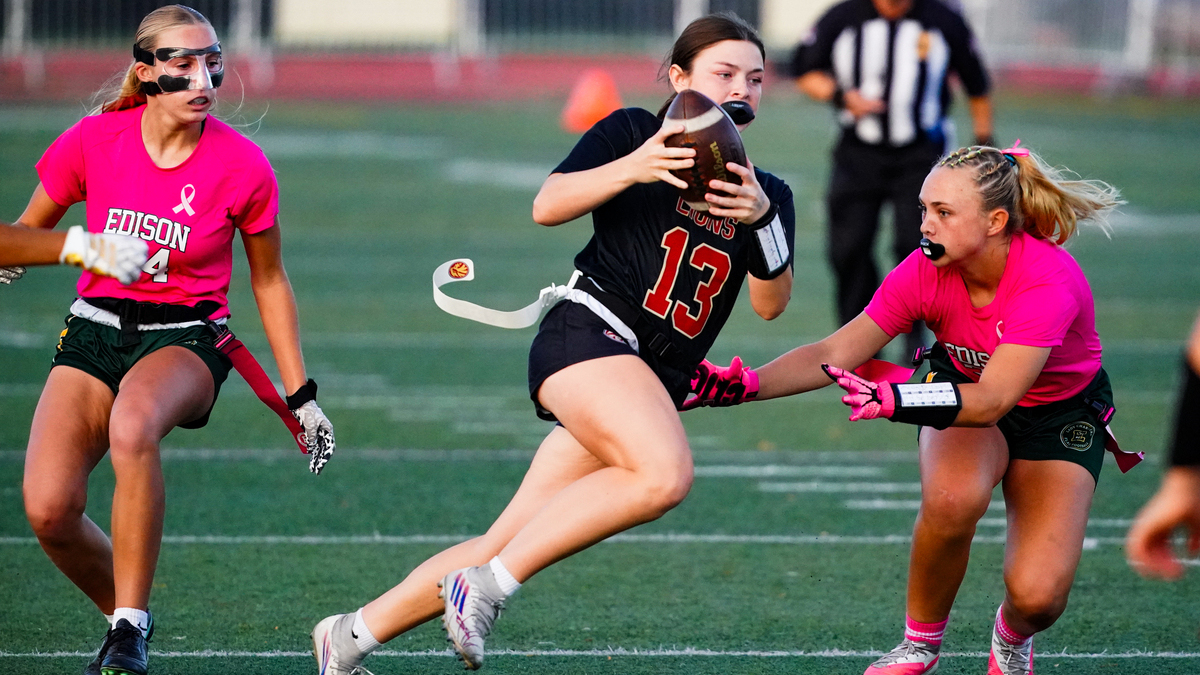 JSerra quarterback Kate Meier runs on a play against Edison defenders in a game between the JSerra Lions and Edison Chargers in the CIF Southern Section Open Division playoffs at JSerra High School in San Juan Capistrano, California on Oct. 28, 2026.
