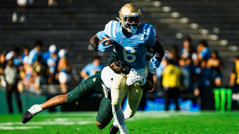 UCLA running back Anthony Woods #6 looks to avoid a tackler during a game against Michigan State at the Rose Bowl in Pasadena, California on Oct. 24, 2026.